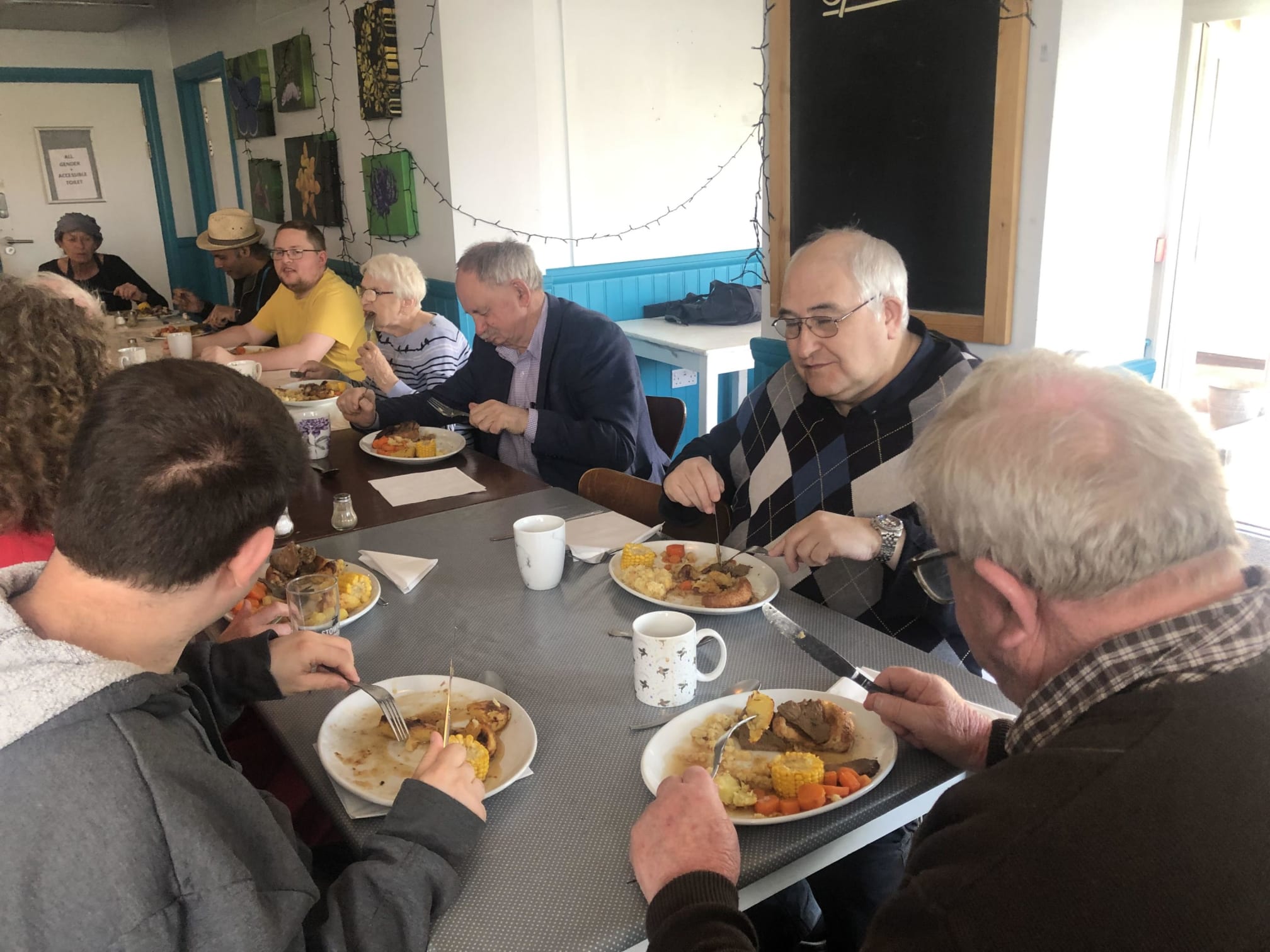 Picture of people having a meal inside a pub