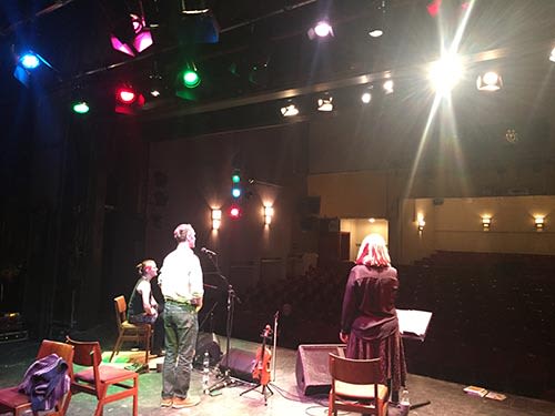 Picture of people on stage in a theatre